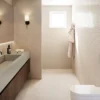 4101_Organic-Dawn_Render1_1920X1080_RGB_170226-copy-1024x576 Minimalist bathroom with dual sinks, wall-mounted faucets, robe hooks, and soft wall lighting.