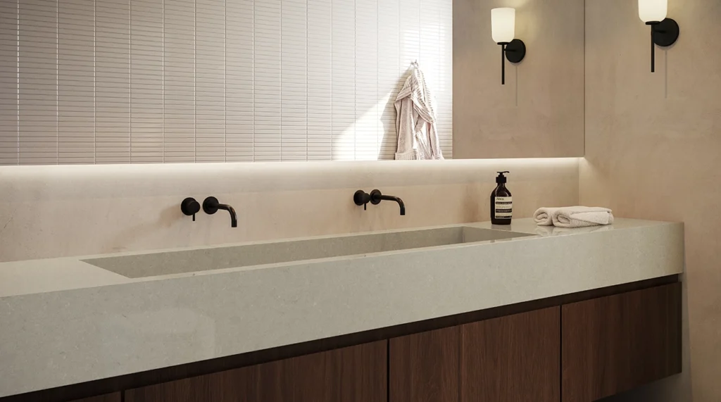 4101_Organic-Dawn_Render2_1282X715_RGB_170226-copy-1024x571 Minimalist bathroom sink with dual black faucets, soap dispenser, towel, and wall-mounted light fixture.