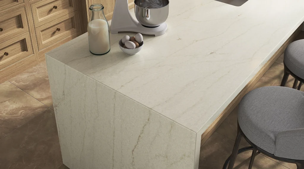 Marble kitchen island with stools, a milk bottle, eggs, and a mixer on top.
