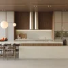 Modern kitchen with large island, wooden cabinetry, hanging spherical lights, and minimalist decor.