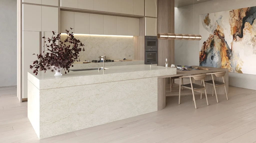 8251_TajWhisper_Render3_1282X715_RGB.jpg-copy-1024x571 Modern kitchen with marble island, wooden dining table, abstract wall art, and minimalist decor.